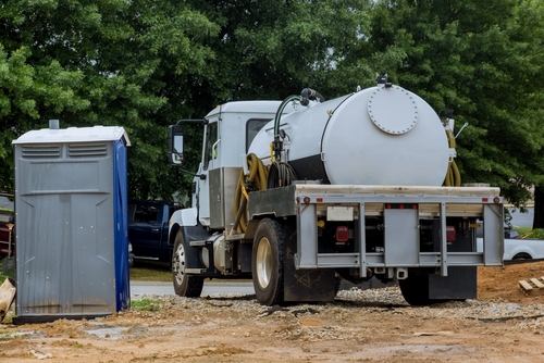 A,septic,vacuum,truck,is,being,used,to,clean,portable